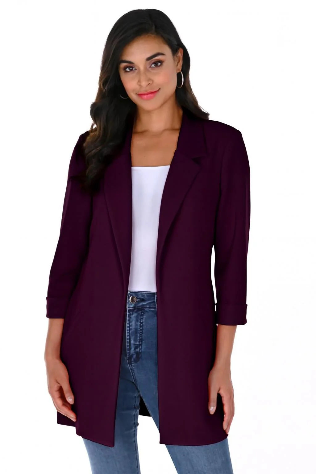 Woman wearing a Plum Cleo Longline Blazer with a relaxed open-front design, rolled cuff sleeves, and slim-fit jeans.