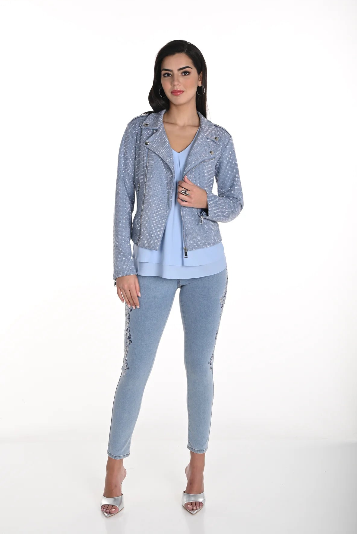 Woman wearing a light blue jacket and pants on a white background