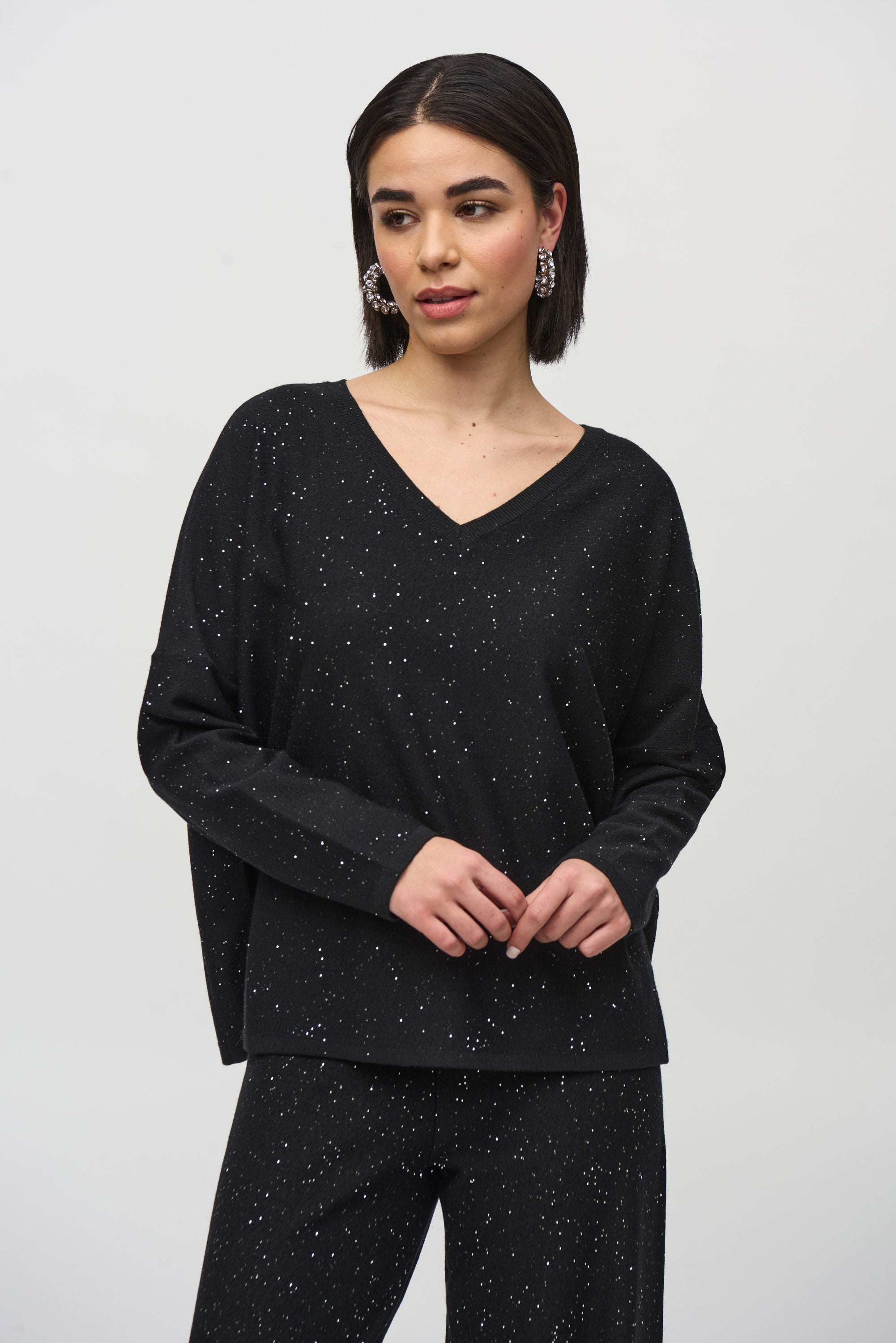 Model wearing a stylish Sequined Sweater Knit Top with a soft V-neckline and elegant drape.