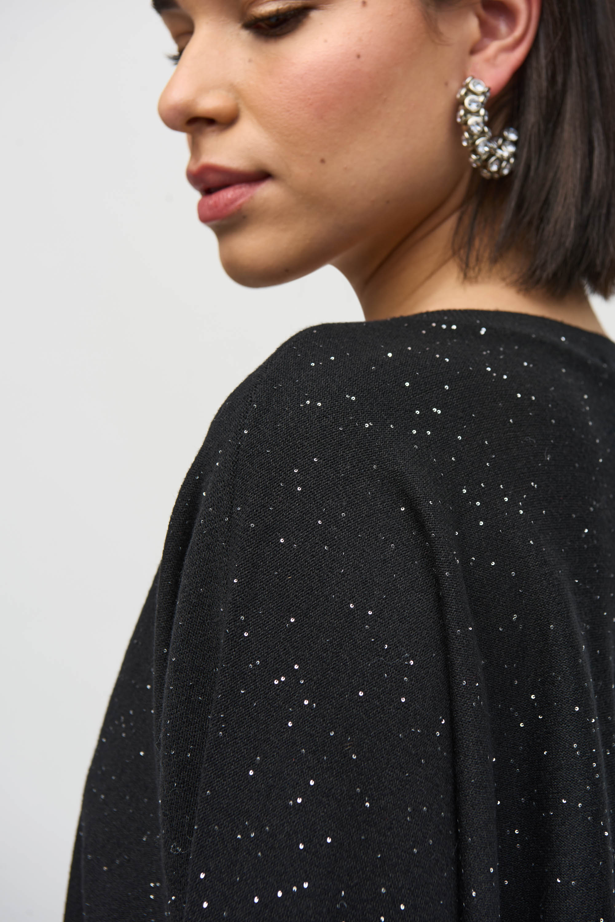 Model showcasing the Sequined Sweater Knit Top with micro-embellishments for a subtle sparkle.