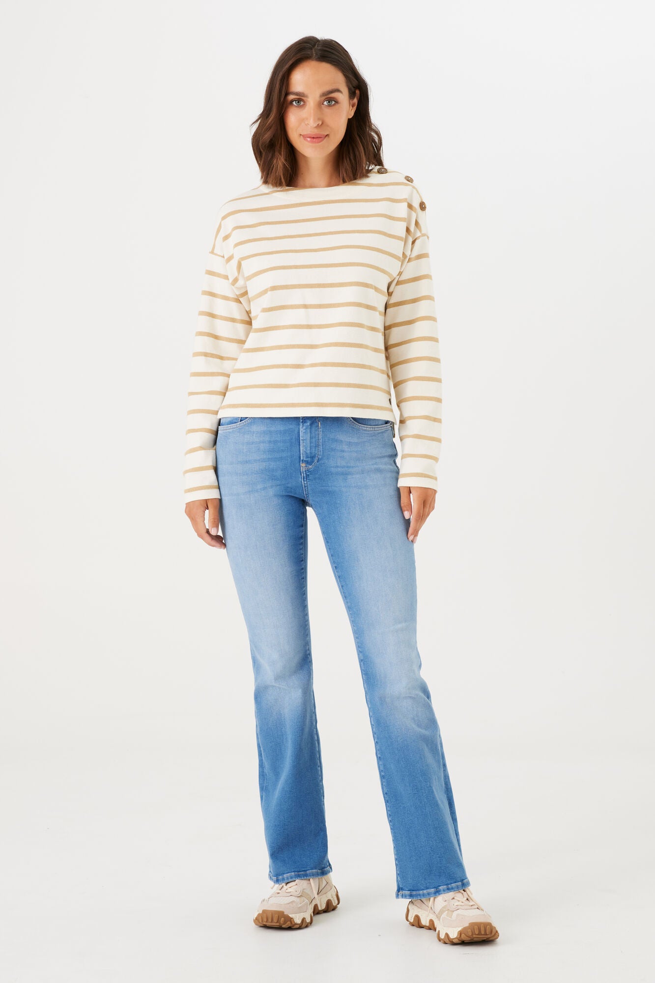 Women's light wash bootcut jeans featuring a mid-rise fit, subtle fading, and a flattering leg-lengthening silhouette.