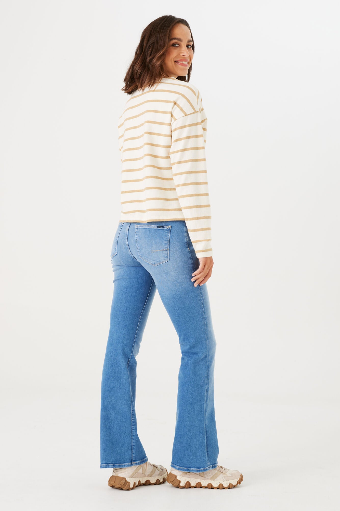 Women's light wash bootcut jeans with stretch denim, shown from the back with a fitted silhouette and classic five-pocket design.