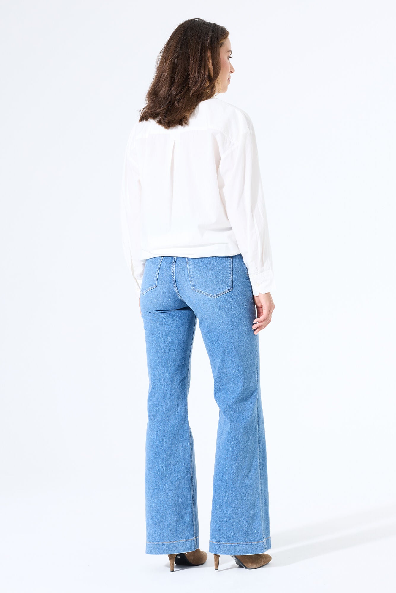 Back view of relaxed wide-leg jeans featuring classic pocket styling and a structured waistband.