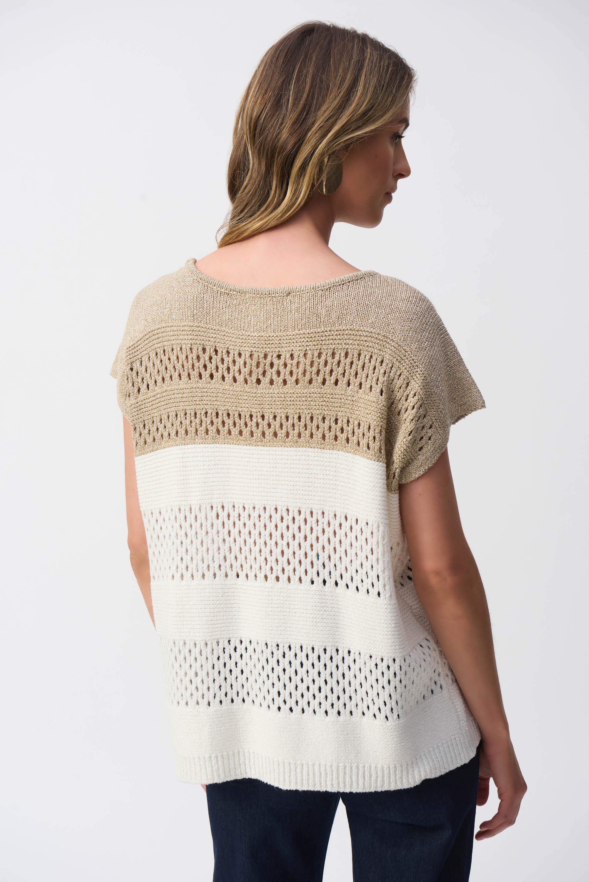 Back view of the sweater featuring the same open stitch pattern and relaxed silhouette with cap sleeves.
