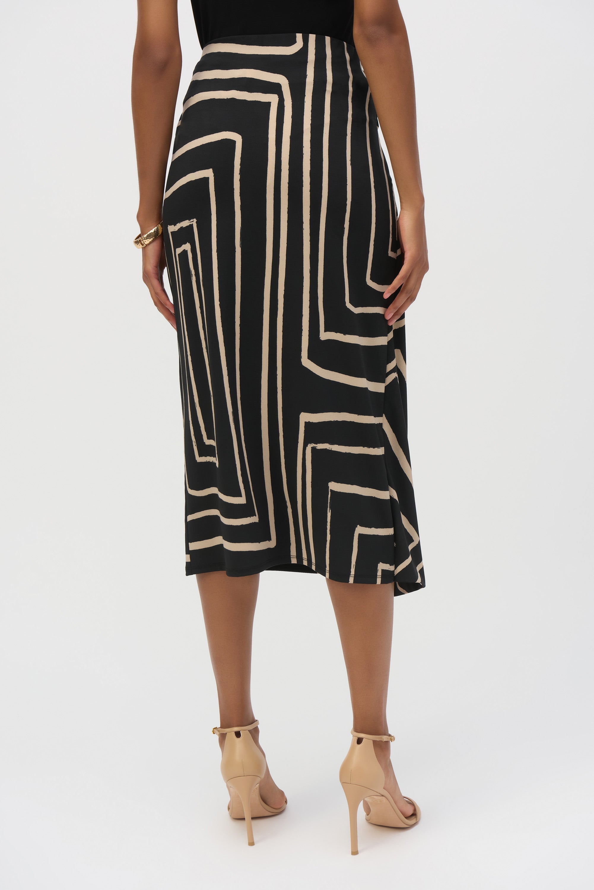 Back view of the black and beige geometric print skirt showing a smooth, fitted silhouette.