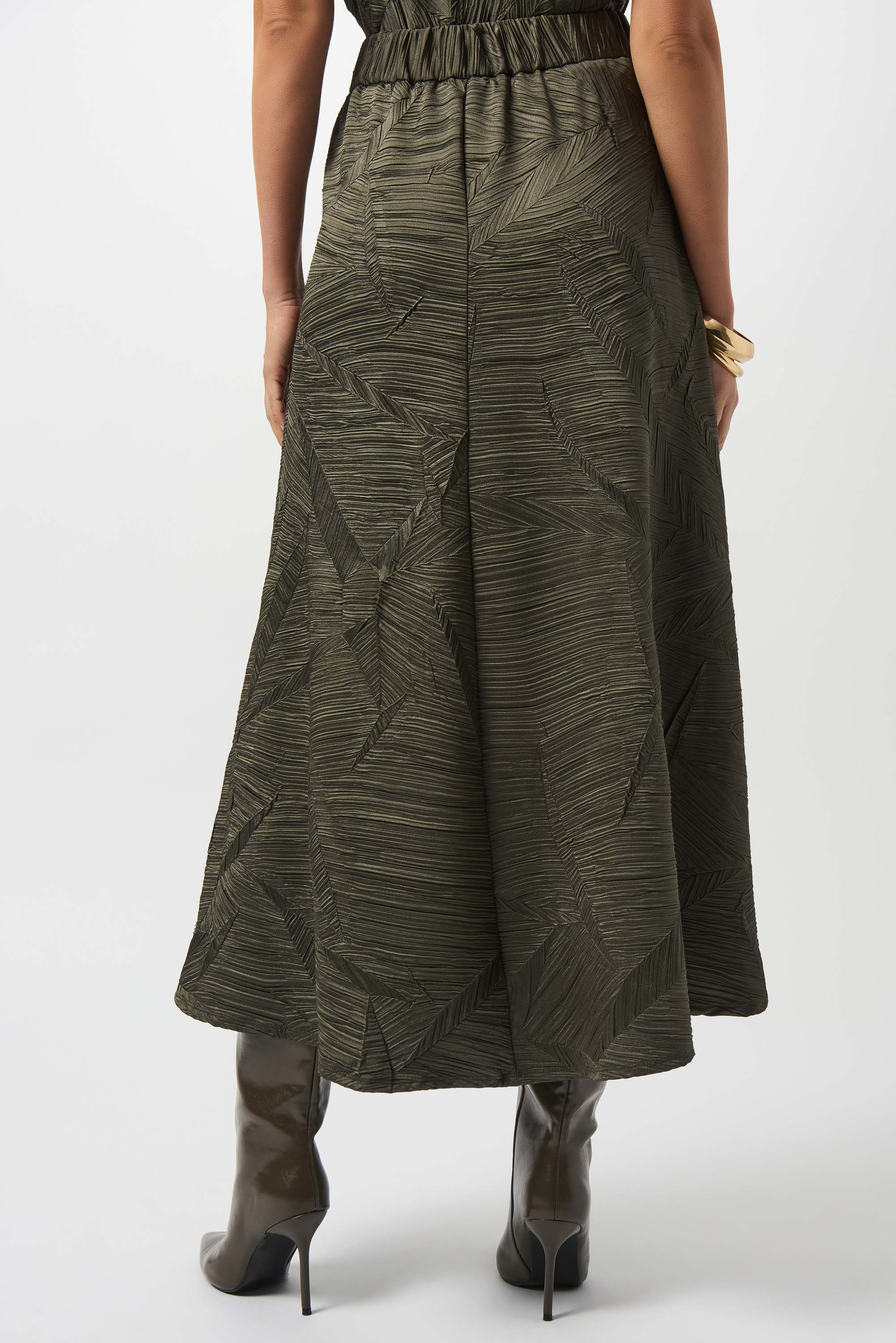 the back of a woman standing, wearing a long dark green skirt