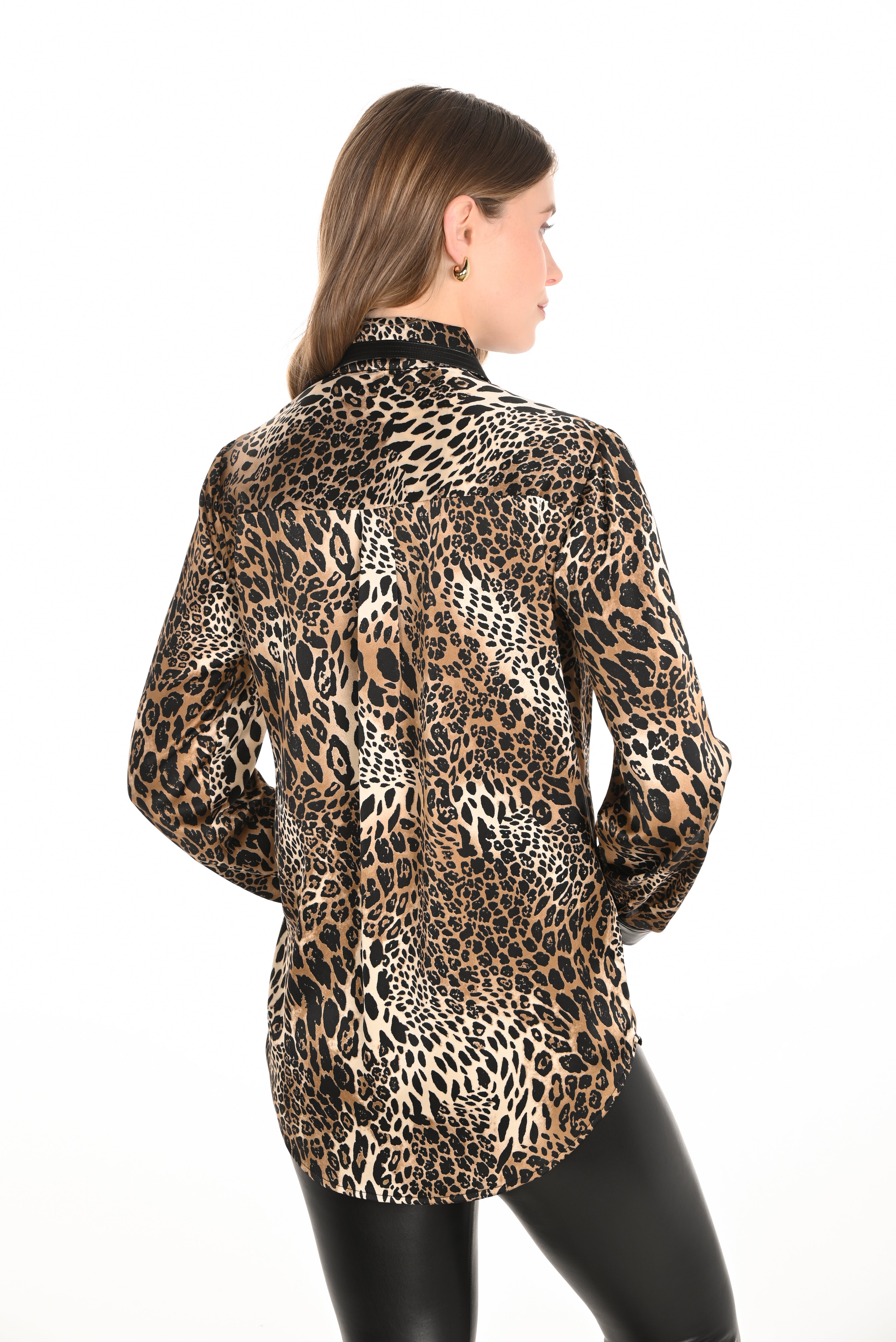Woman wearing a leopard print shirt on a white background