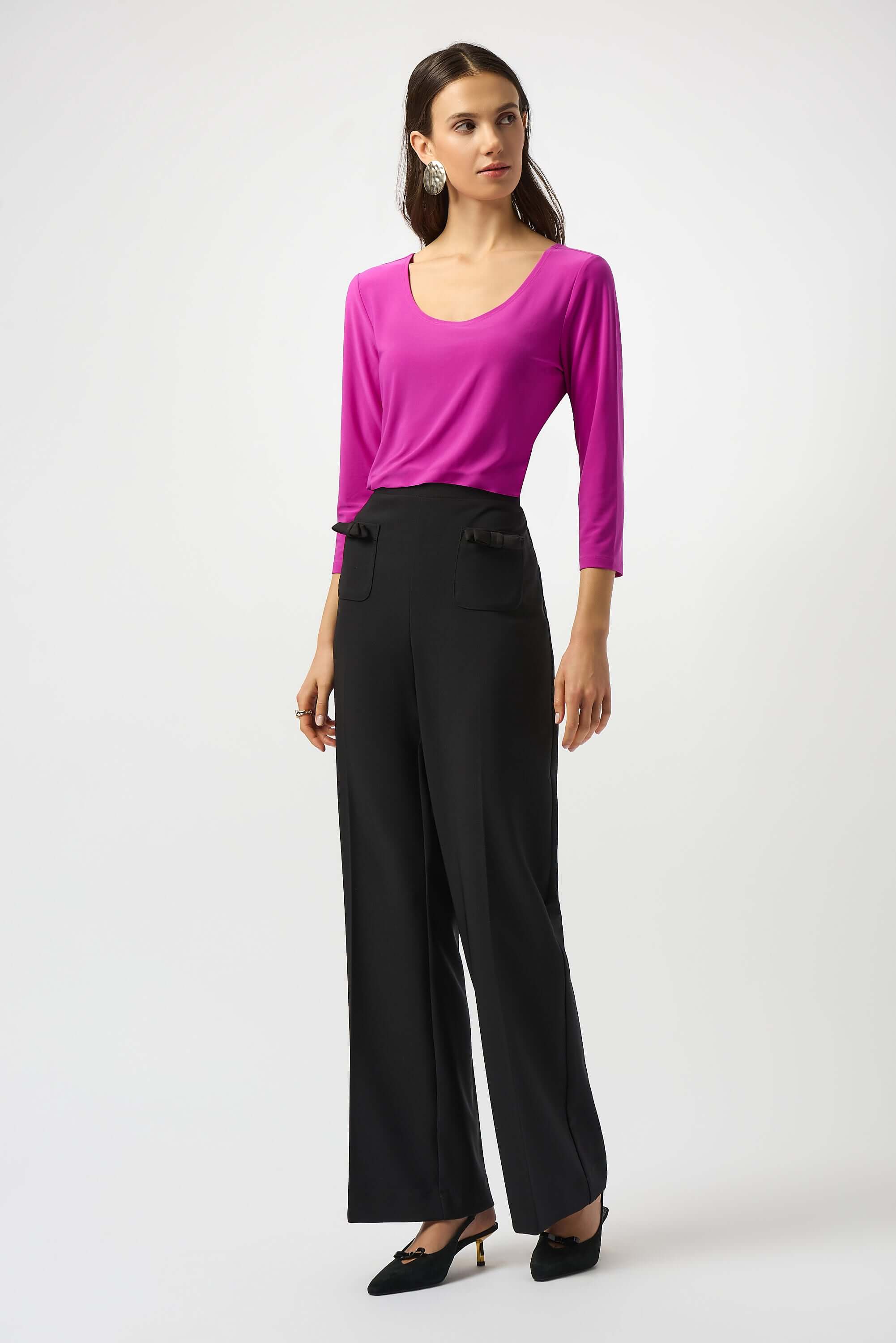 Model wearing Silky Knit Scoop Neck Fit & Flare Top in pink with black trousers, showcasing a chic outfit by Joseph Ribkoff.