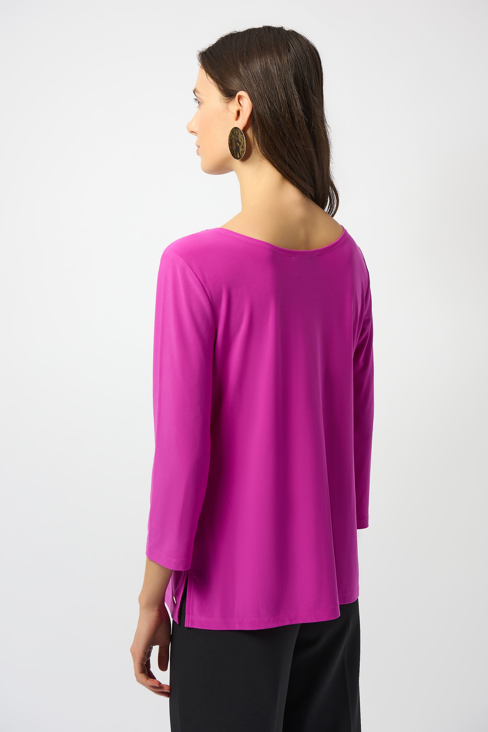 Back view of a woman wearing a pink Silky Knit Scoop Neck Fit & Flare Top with three-quarter sleeves.