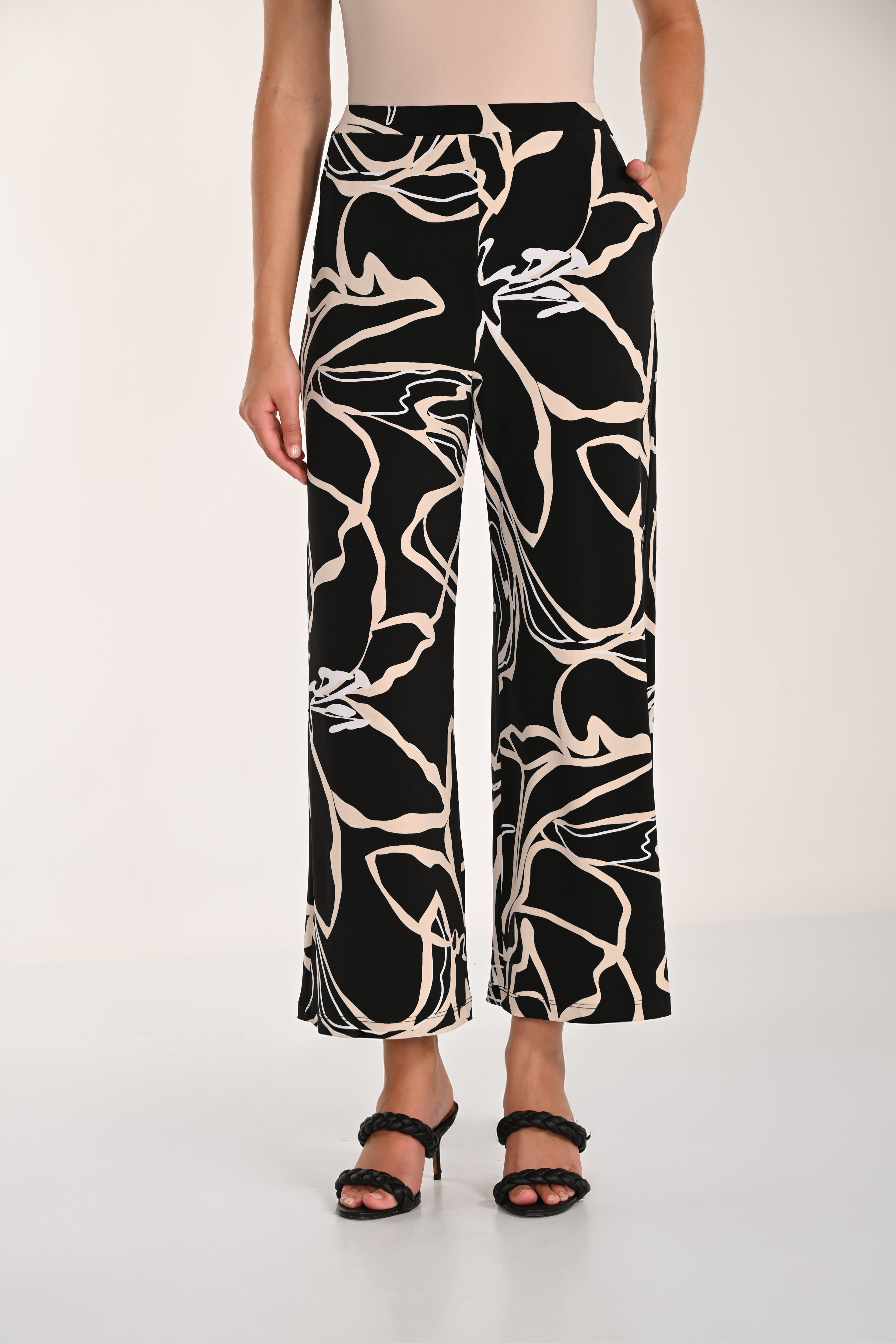 Close-up view of the Avenue Wide-Leg Pant featuring an abstract print, wide-leg silhouette, and relaxed drape with front pockets.