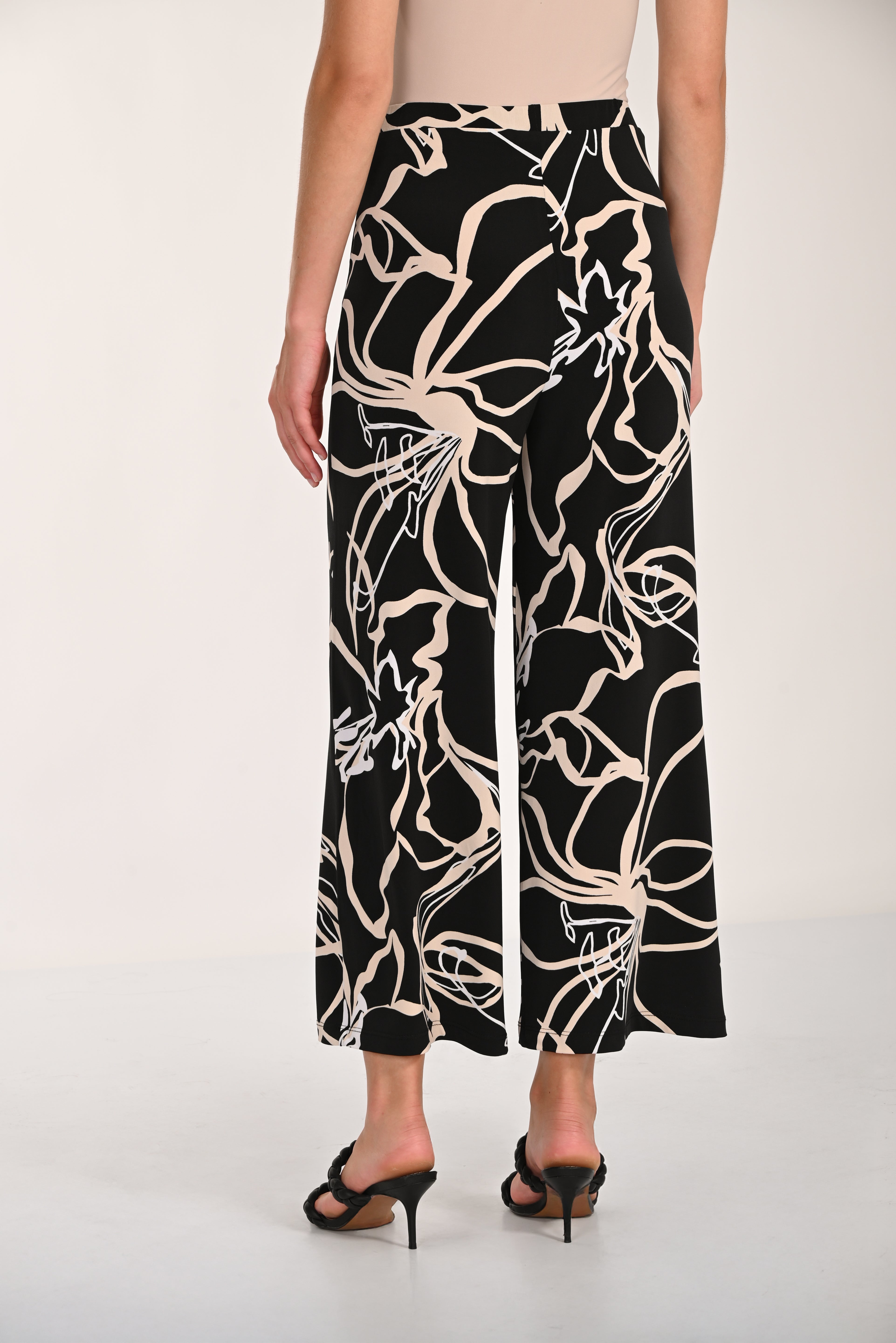 Close-up view of the Avenue Wide-Leg Pant featuring an abstract print, wide-leg silhouette, and relaxed drape with front pockets.