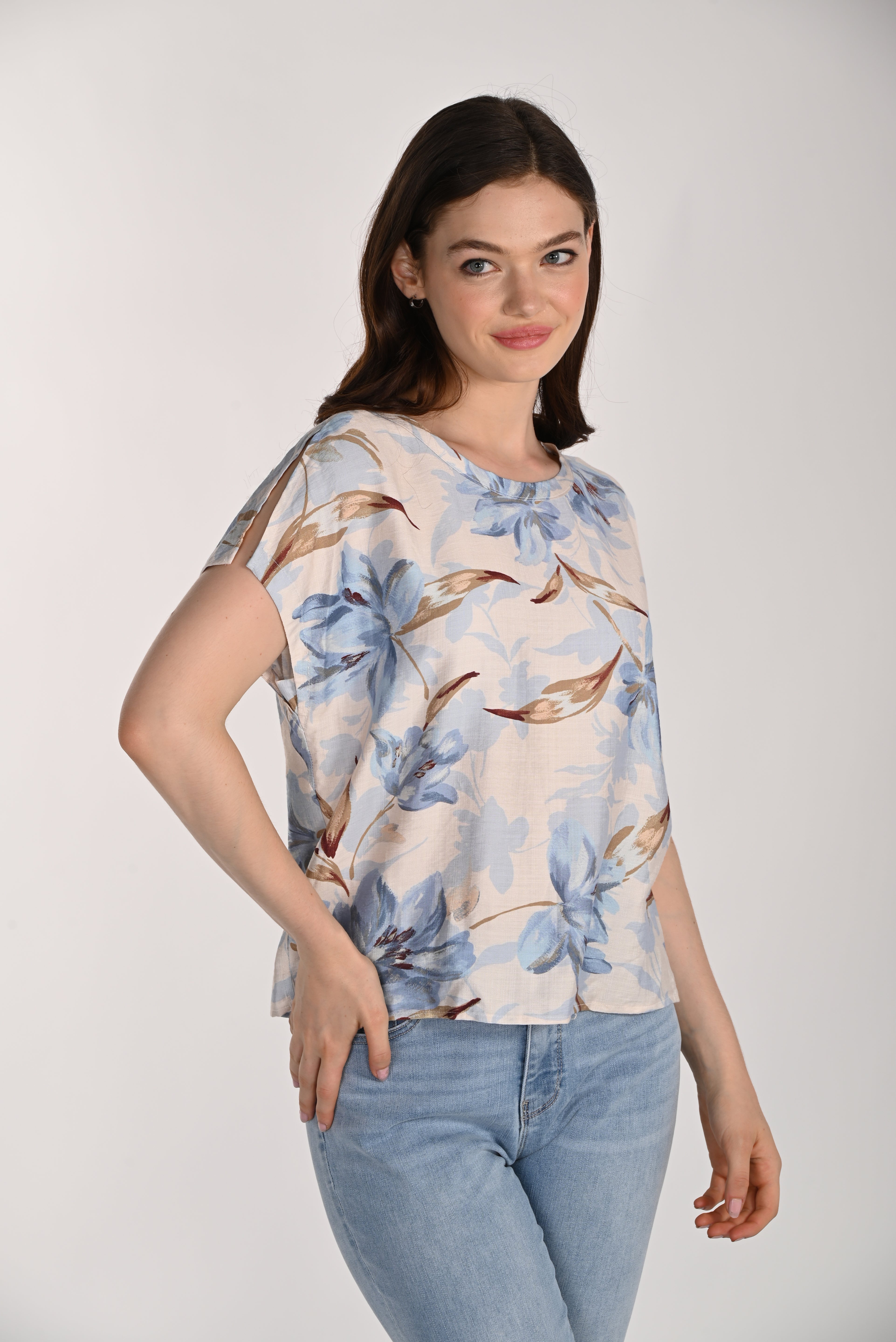 Women's floral print blouse with a relaxed fit, round neckline, and short split sleeves. Styled with light wash jeans, the lightweight woven fabric offers a soft drape and effortless everyday appeal.