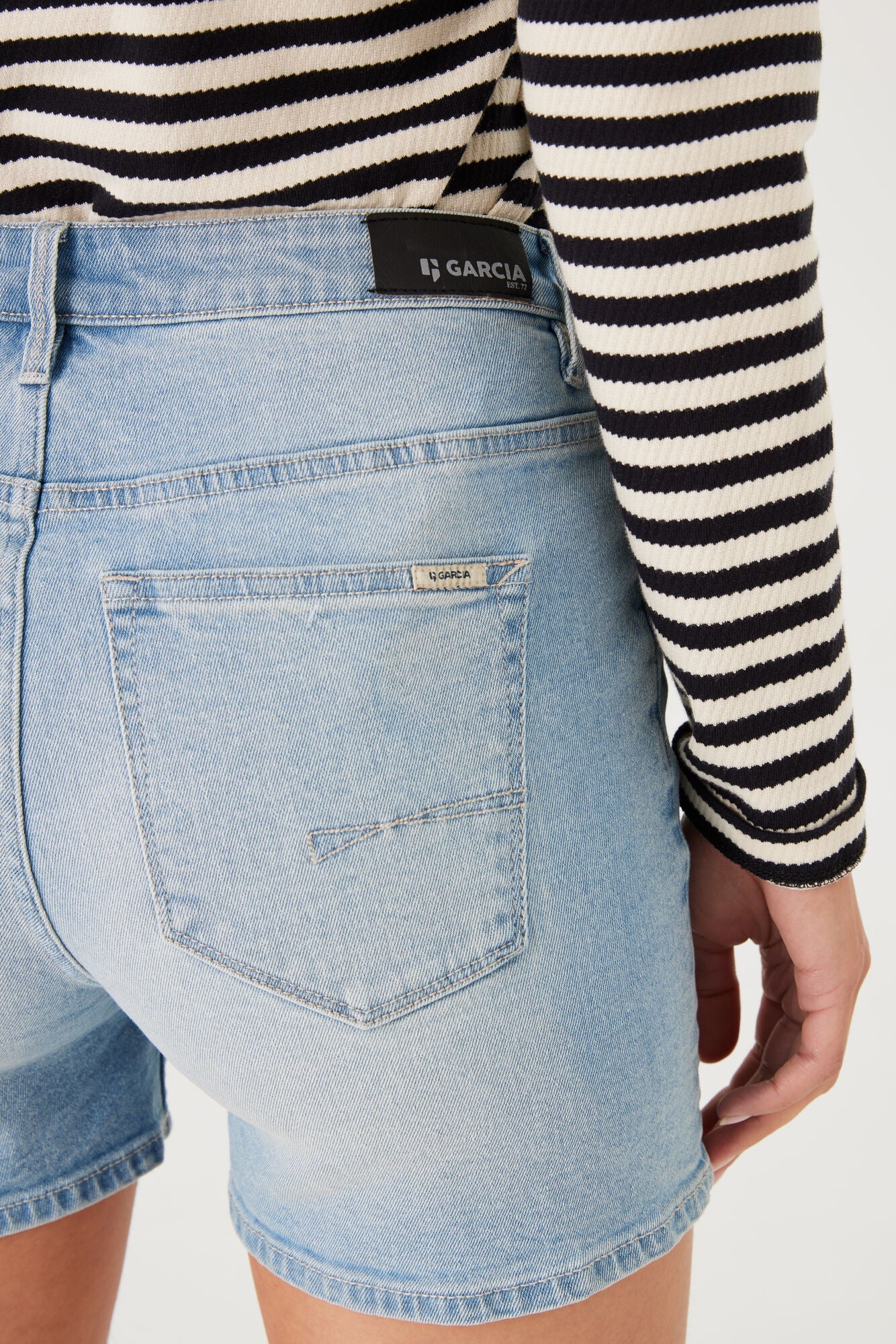 Close-up back view of the shorts showing the waistband, pocket detail, and subtle branding patch.