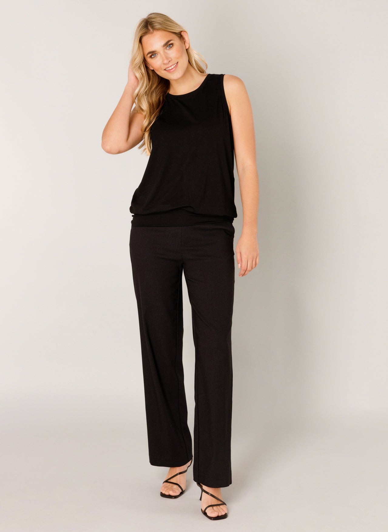 Women's black sleeveless top and straight-leg trousers co-ord set, featuring a relaxed fit, round neckline and side pockets.