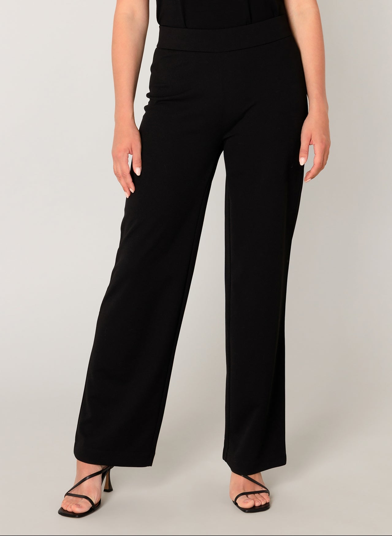 Women's black wide-leg knit pants with a comfortable pull-on waistband and fluid drape. Front view highlighting the clean lines and relaxed fit through the leg.