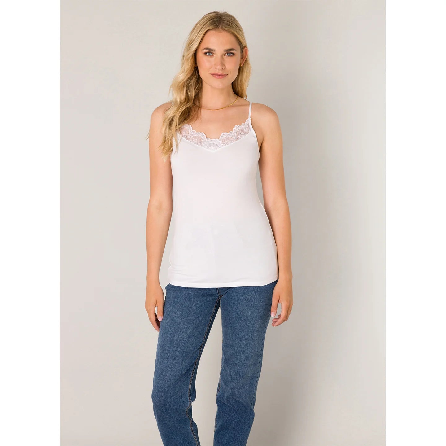 Front view of a lace trim cami with a flattering V-neckline, adjustable spaghetti straps, and a soft, draped silhouette.