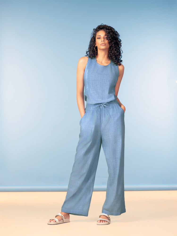 Women’s sleeveless tank top with a relaxed silhouette and soft drape, paired with wide-leg woven pants to show versatility for casual or polished styling.