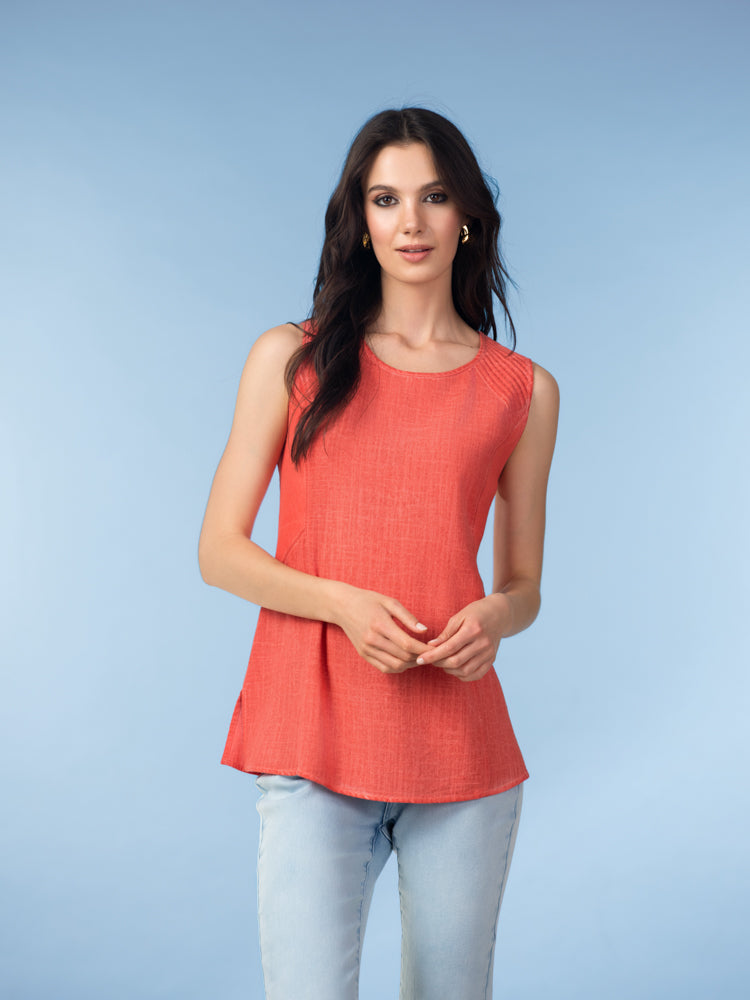 Women’s sleeveless tank top with a relaxed fit, scoop neckline, and smooth knit fabric, styled with slim-fit jeans for an easy everyday look.