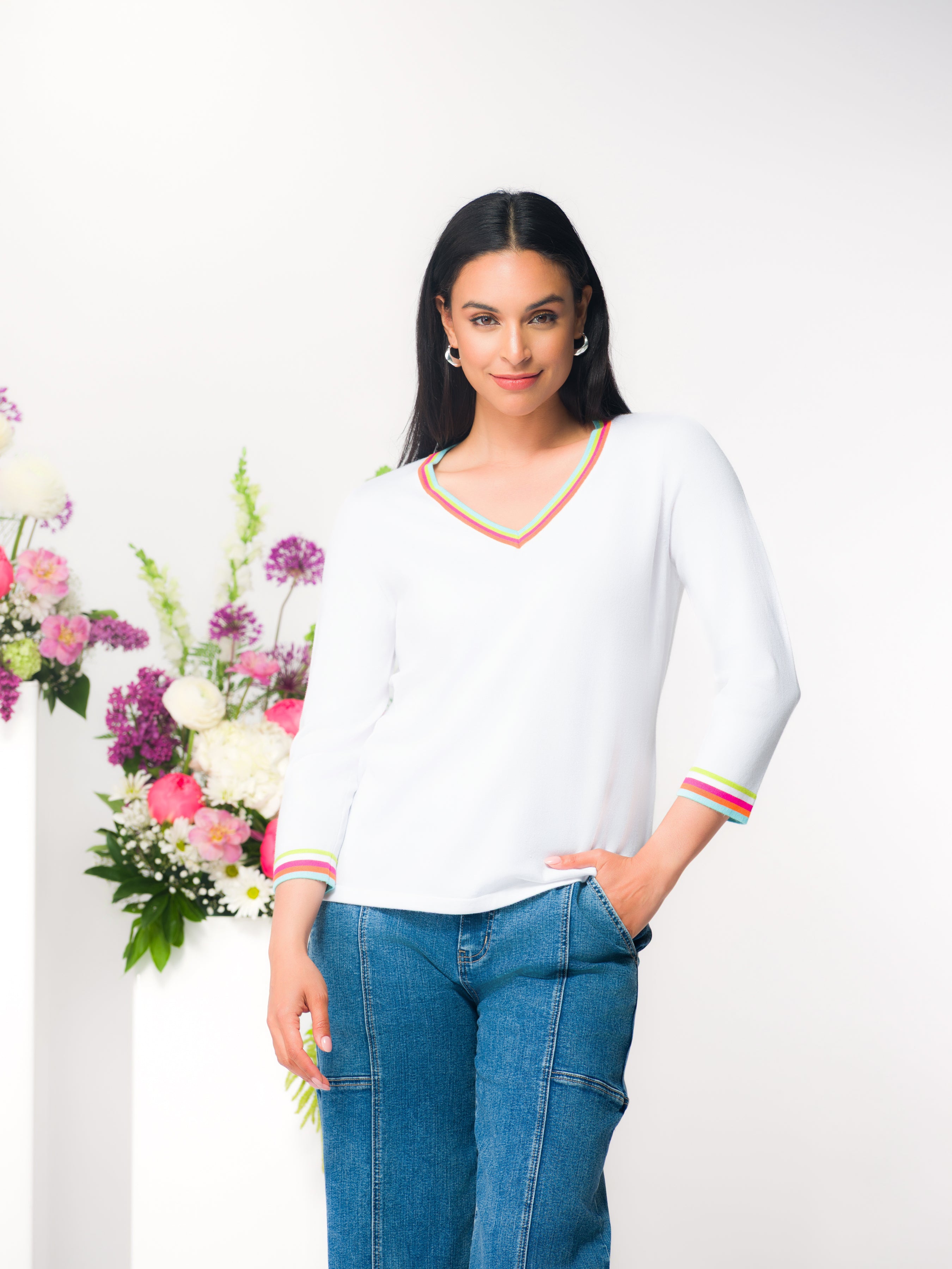 Women’s V-neck knit top with a patterned design, three-quarter length sleeves, and a relaxed, draped silhouette shown on a model.