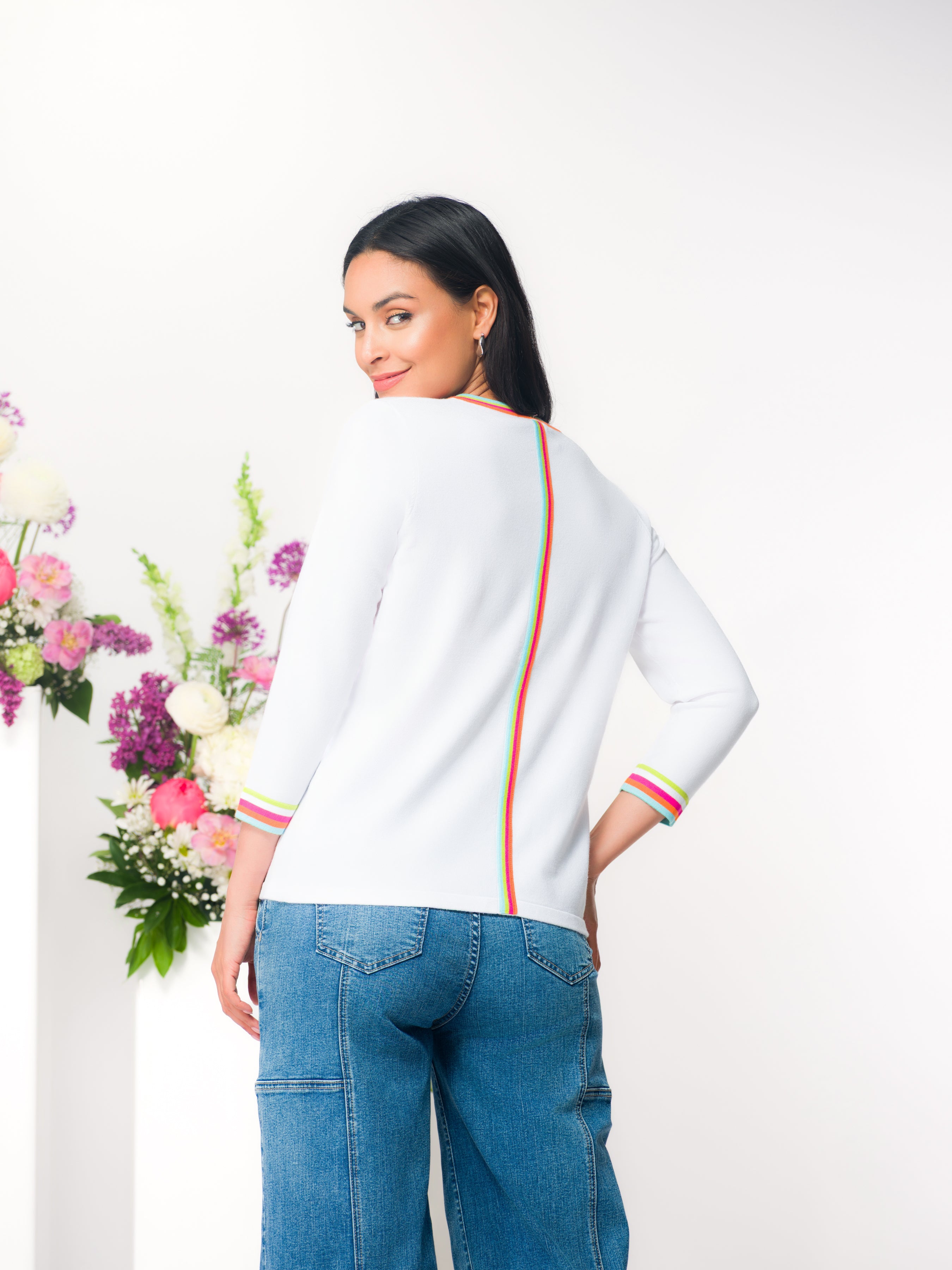 Back view of a women’s patterned knit top featuring a relaxed fit, three-quarter length sleeves, and a smooth, lightweight drape.