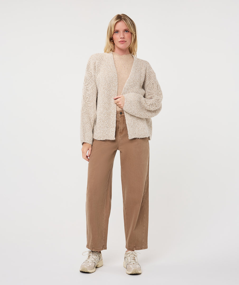 Woman wearing the Haven Textured Knit Cardigan with a crew-neck top, straight-leg trousers, and casual sneakers.