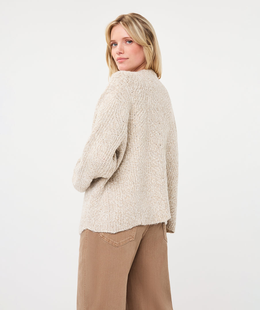 Back view of a woman wearing the Haven Textured Knit Cardigan, showcasing its relaxed fit and textured knit finish.