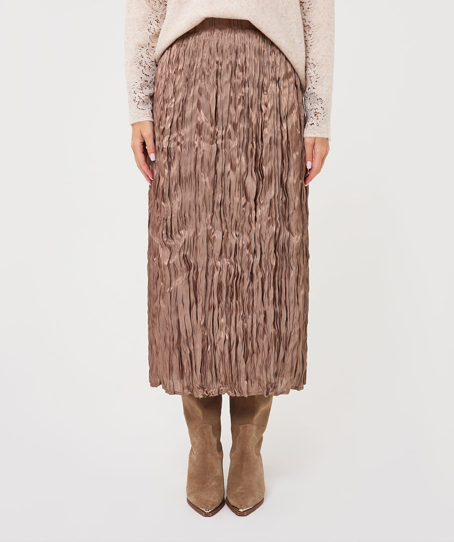 Close-up of the Elara Crinkle Midi Skirt in taupe, highlighting its crinkled texture, elasticated waistband, and flowing midi-length design.