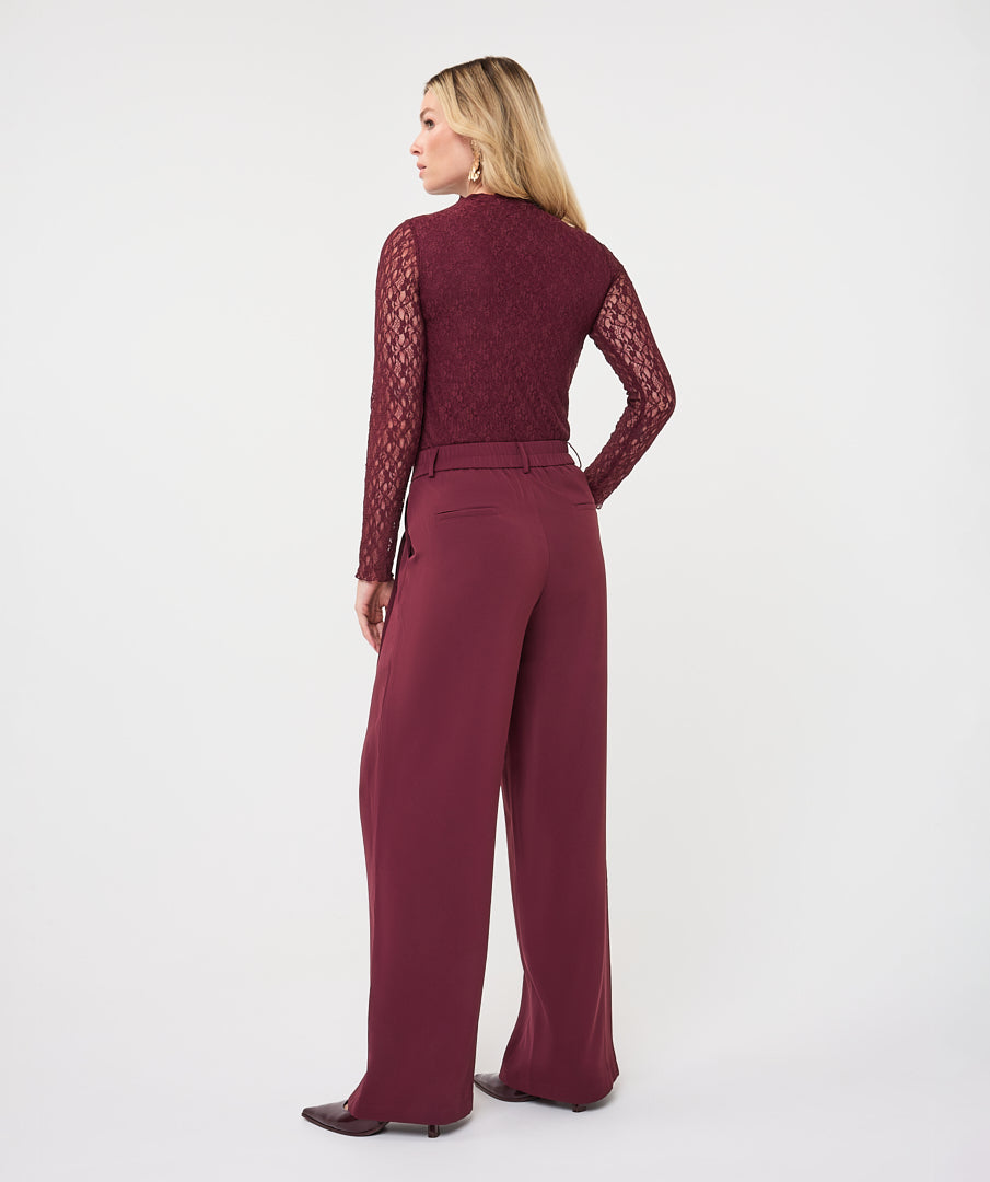 Model wearing merlot wide-leg trouser