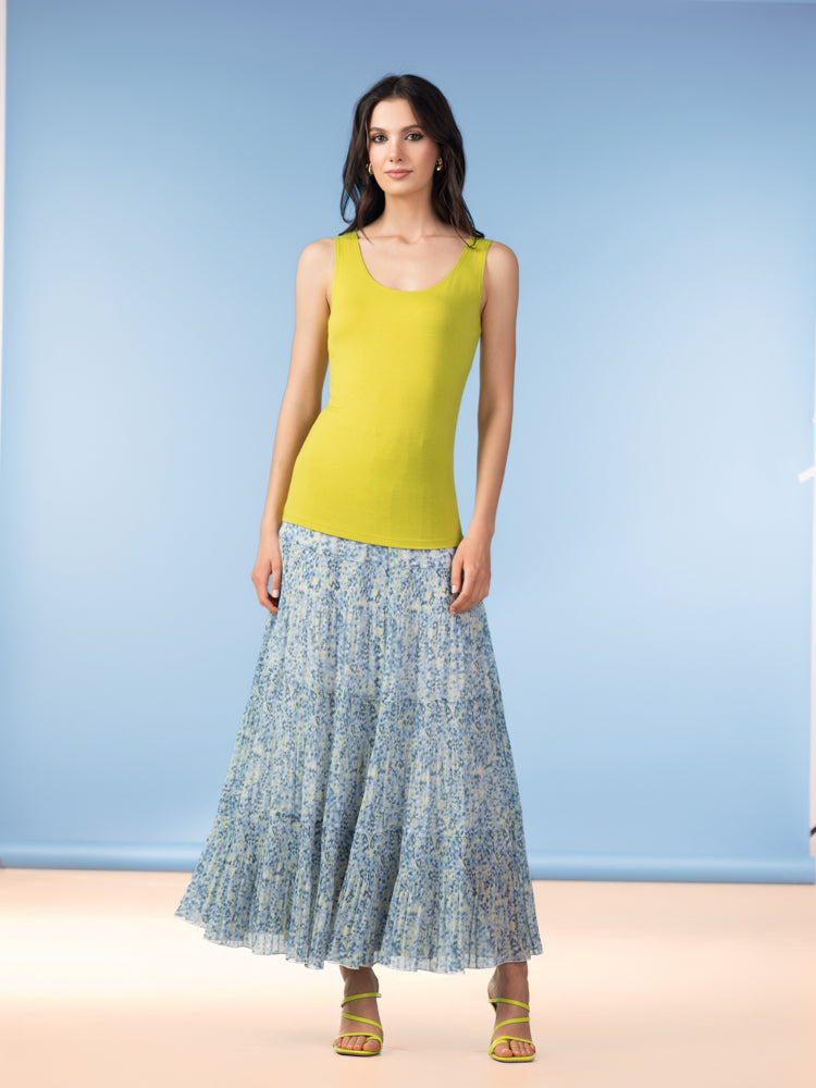 Women’s lime yellow sleeveless scoop-neck tank top styled with a blue floral maxi skirt and matching green sandals.