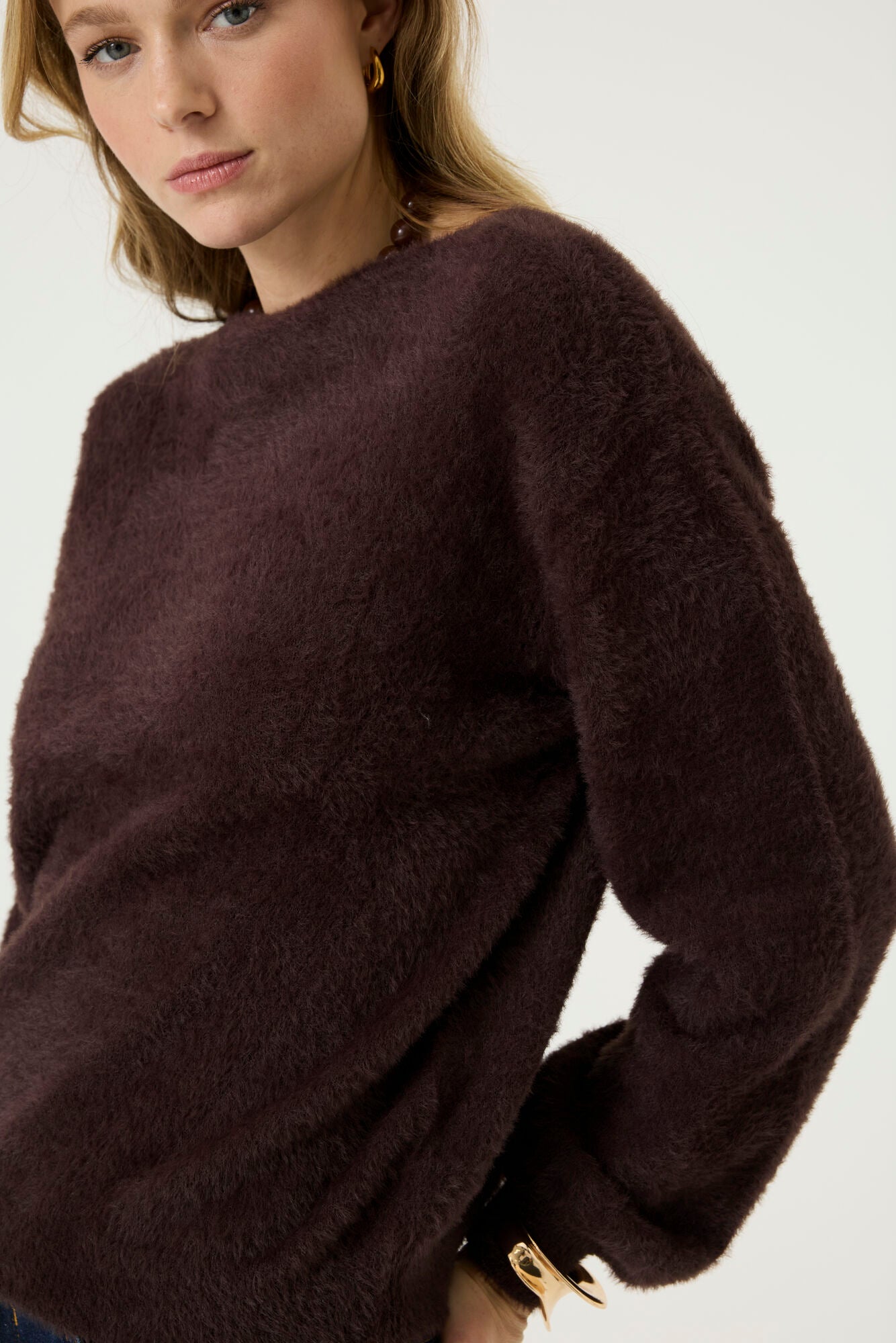 Model wearing the Alora Soft Texture Sweater in rich brown, showcasing its soft textured knit and crew neckline.