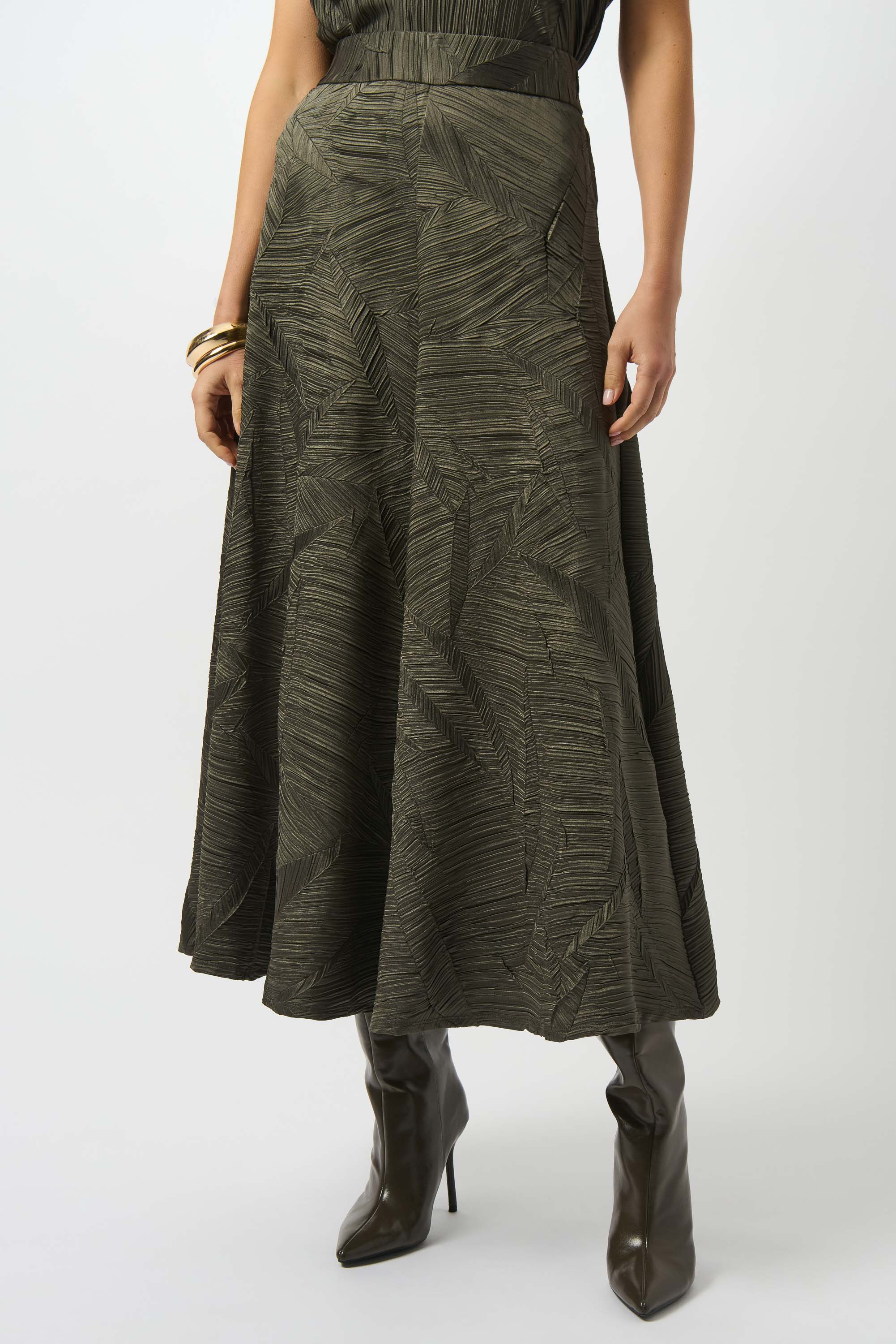 a closer-up image of a woman standing wearing a dark green long skirt