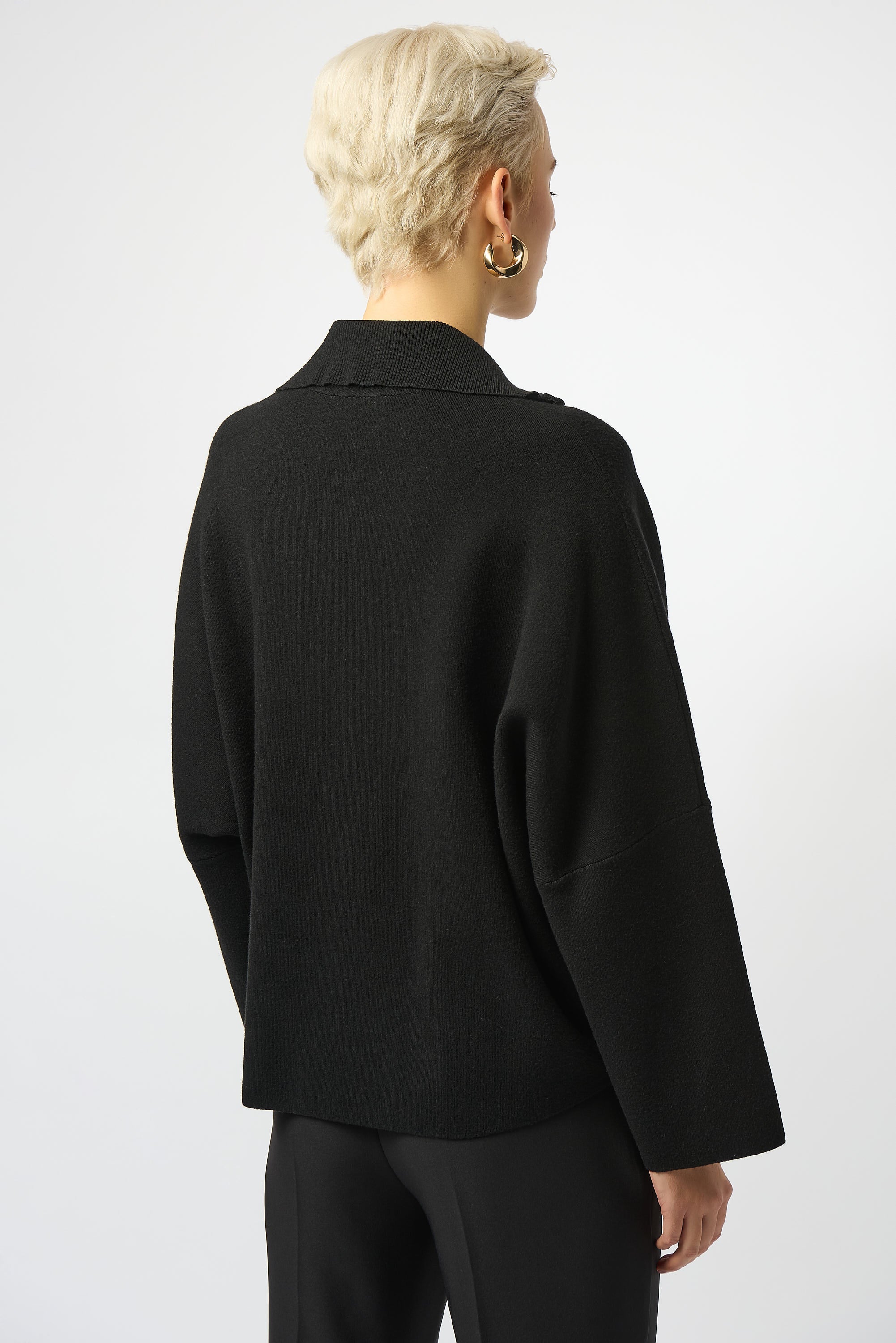 woman standing in black sweater
