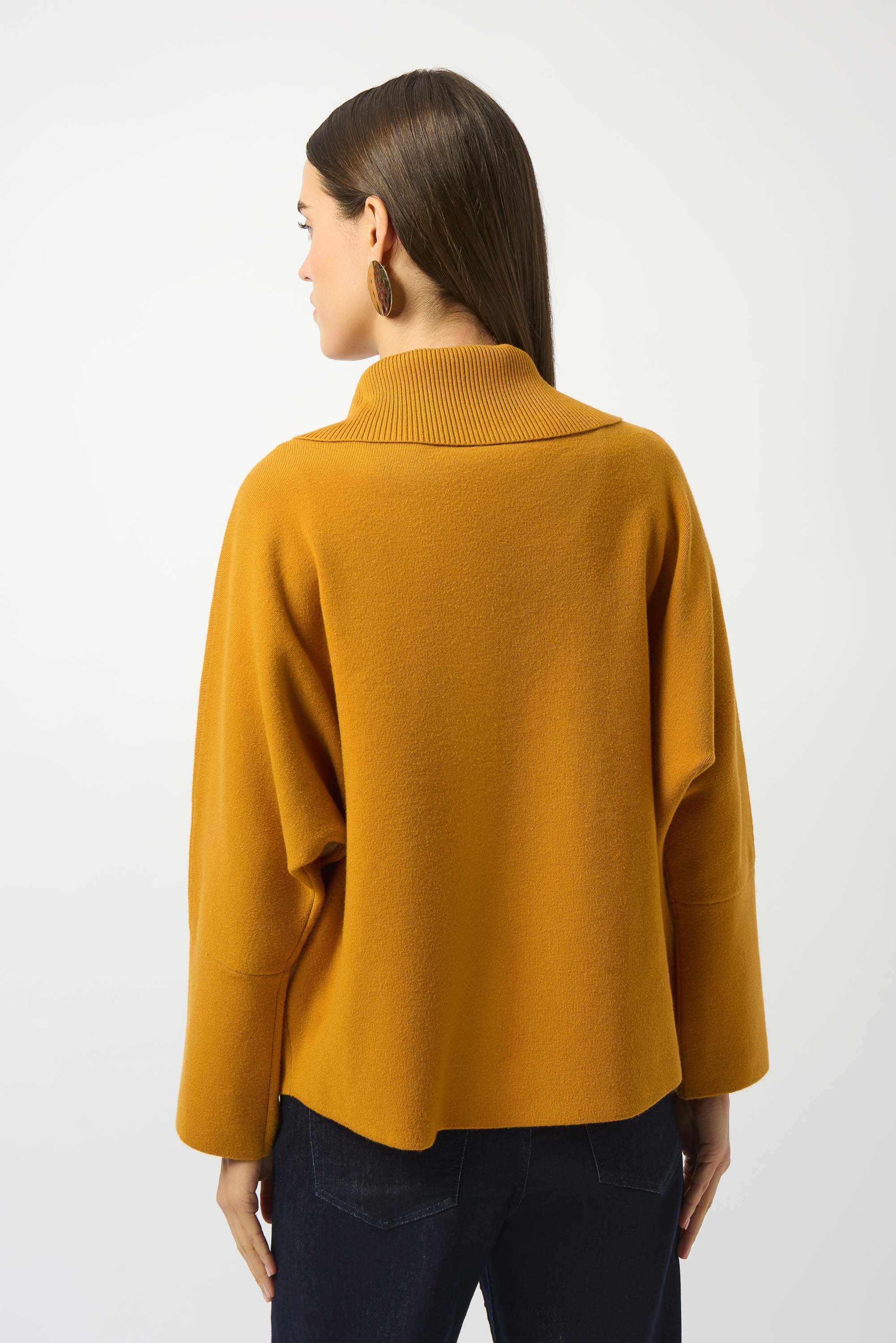 woman standing in mustard yellow sweater