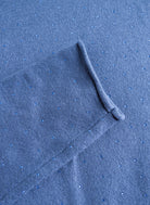 Close-up of blue turtleneck sweater's sparkle detailing and ribbed cuff texture.
