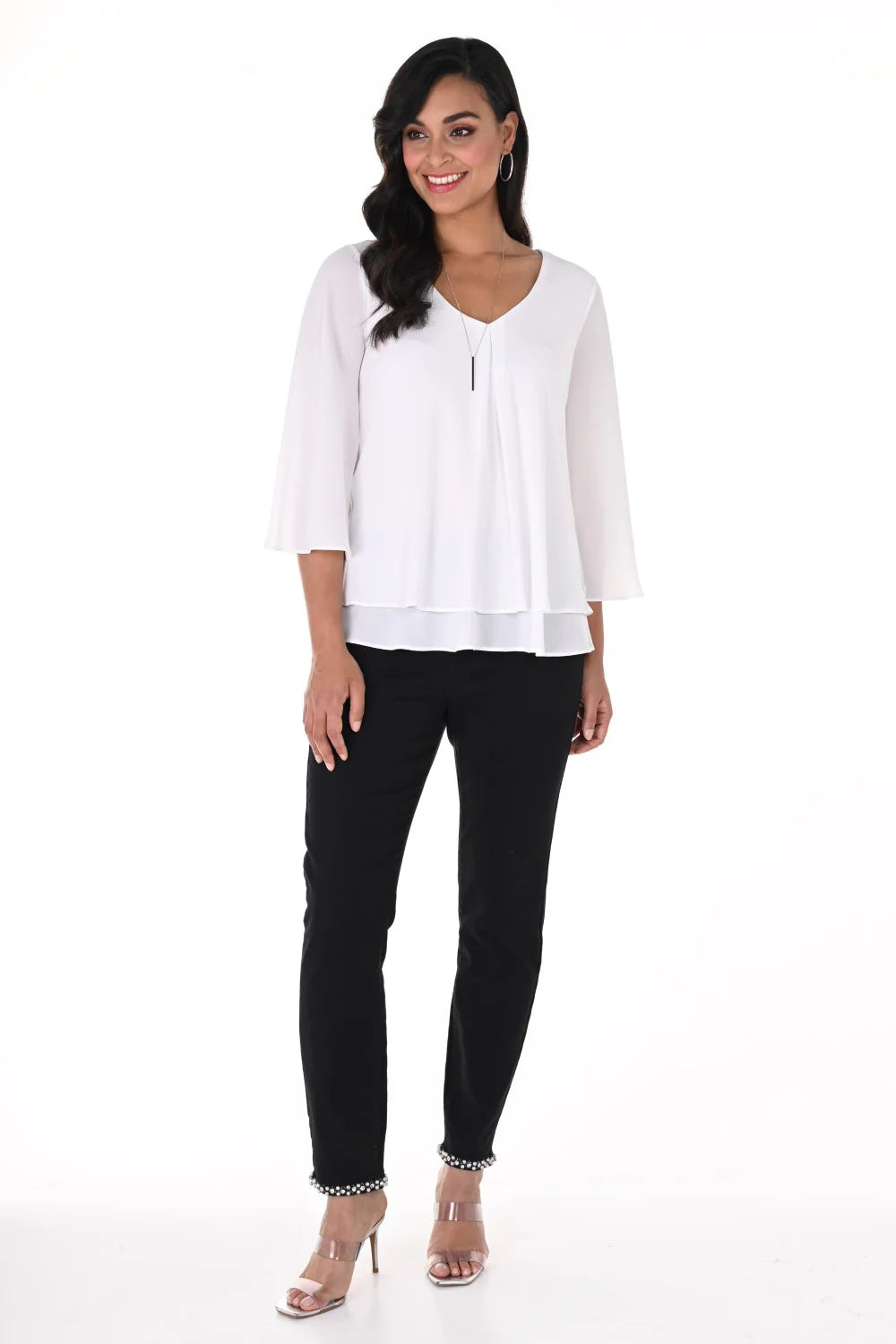 Layered chiffon flounce sleeve top worn with stylish black trousers, featuring soft sleeves and a flattering V-neckline.