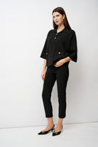 Woman wearing a black outfit with a white background