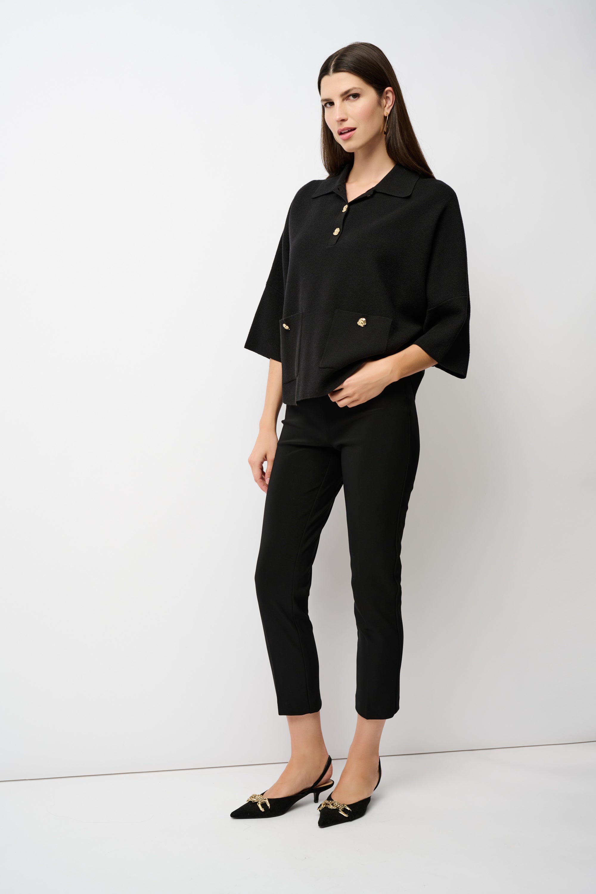 Woman wearing a black outfit with a white background