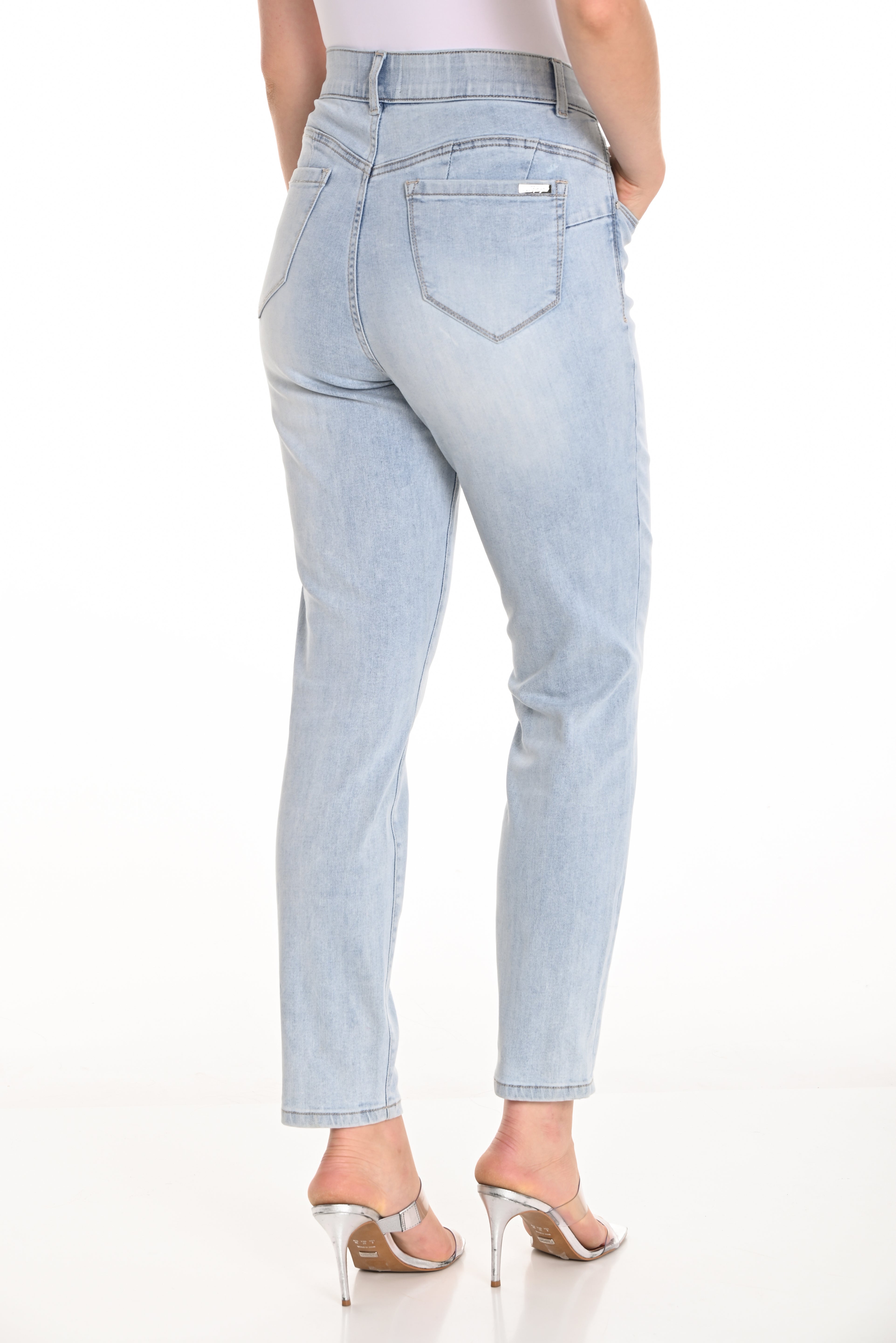 Back view of high-rise comfort stretch slim jeans showcasing a tapered leg and smooth waistband for a sleek silhouette.