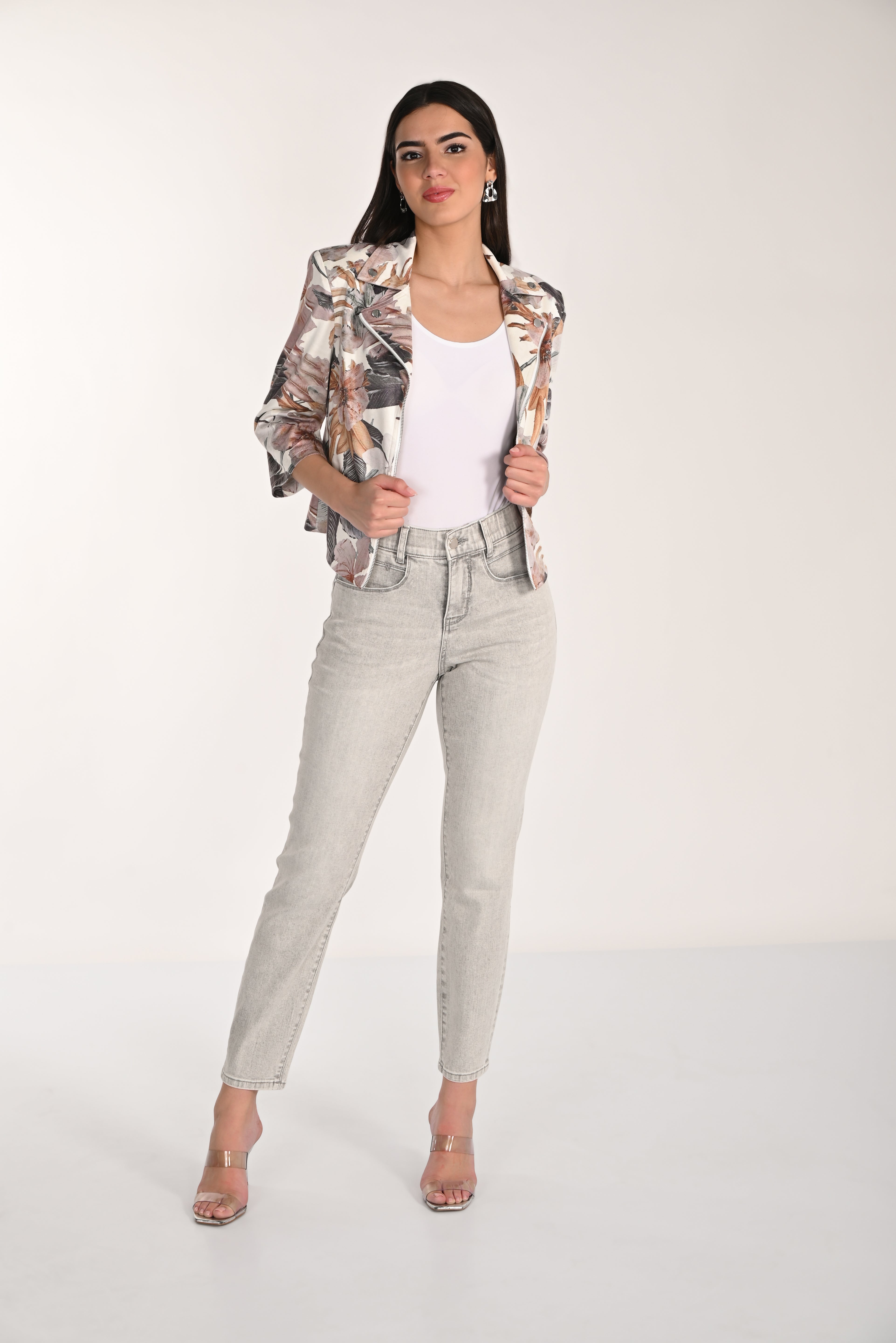 Model wearing high-rise comfort stretch slim jeans with a floral blazer, perfect for both work and casual outings.
