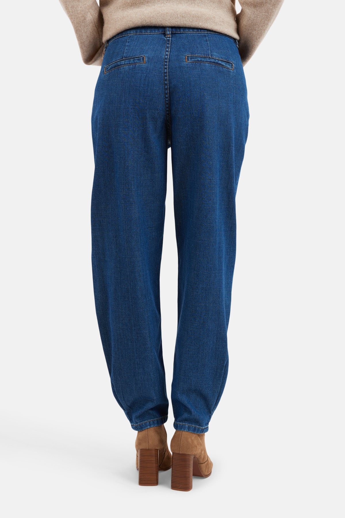 Back view of tapered barrel-leg jeans in blue, showcasing a modern barrel-leg silhouette.