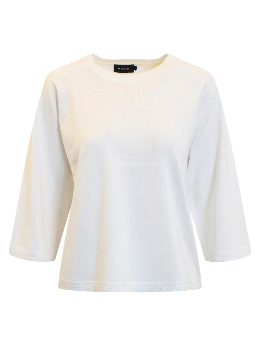 White sweater with a subtle pattern on a white background