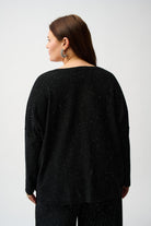 Back view of a model wearing a Sequined Sweater Knit Top with a relaxed fit and micro-embellishments.