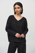 Model wearing a stylish Sequined Sweater Knit Top with a soft V-neckline and elegant drape.