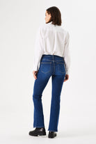 Back view of women's dark blue bootcut jeans featuring a mid-rise waist, classic five-pocket design, and subtle stretch denim.