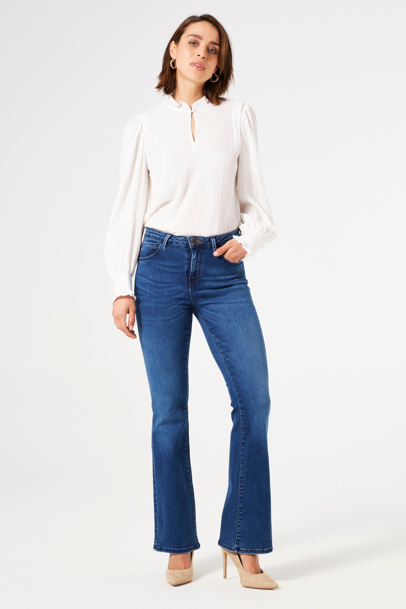 Women's mid-rise blue flare jeans with stretch denim, fitted through the hips and thighs with a flattering flared leg silhouette.