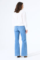 Back view of relaxed wide-leg jeans featuring classic pocket styling and a structured waistband.