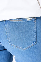 Close-up of cotton denim fabric with subtle texture and slight stretch.