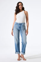Model wearing high-rise straight-leg jeans with a fitted tank top and heeled sandals, shown from the front to highlight the fit and silhouette.