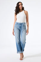 Model wearing high-rise straight-leg jeans with a fitted tank top and heeled sandals, shown from the front to highlight the fit and silhouette.