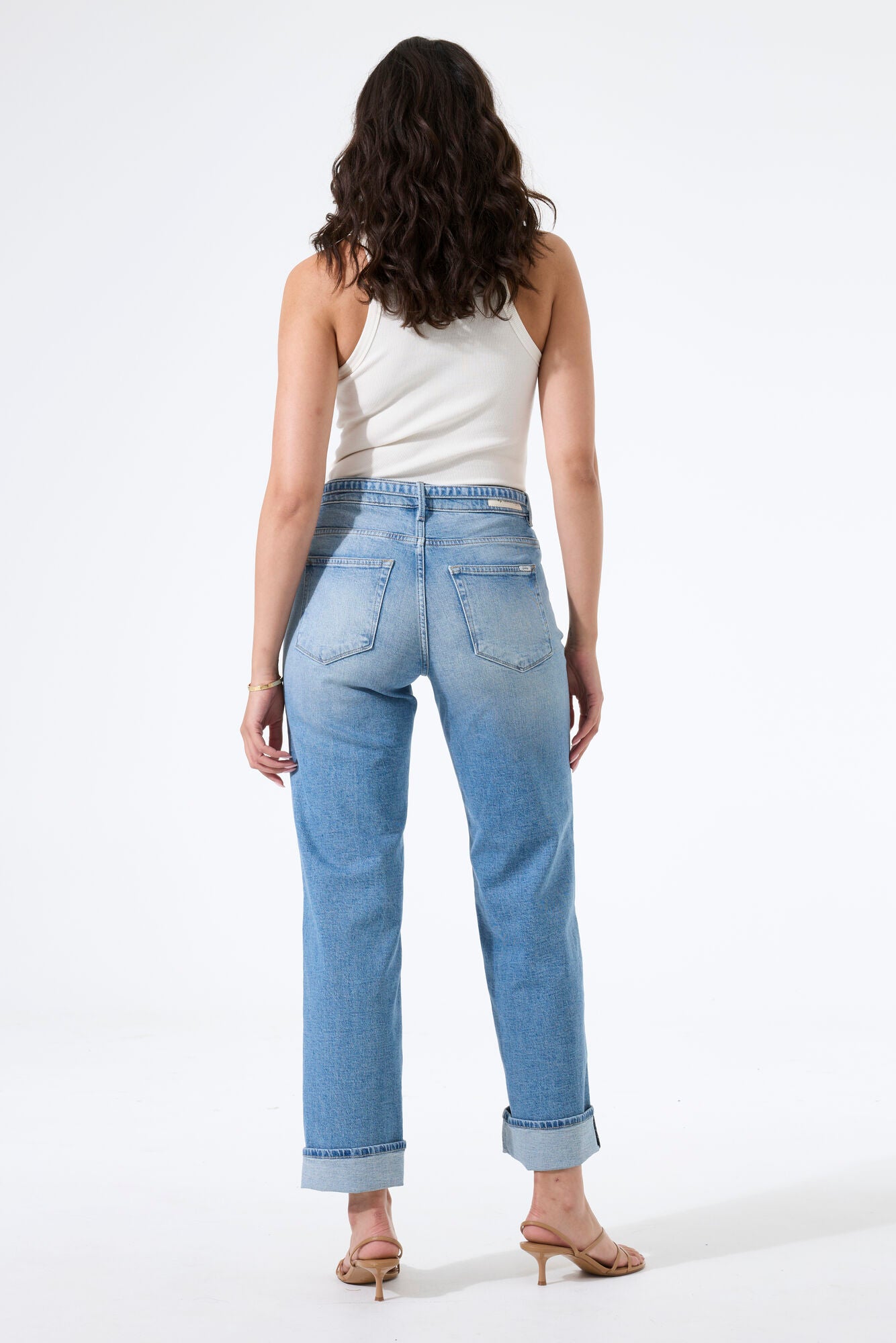 Back view of model wearing high-rise straight-leg jeans, showing the rear fit, pocket placement, and straight-leg silhouette.